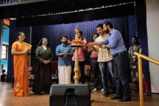 Dr Nithish T Jacob and Feny Joy lighting the lamp